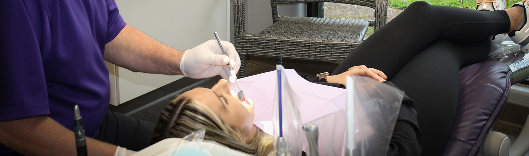 Patient getting dental exam at Green & DiLeo Dentistry in Orange, TX